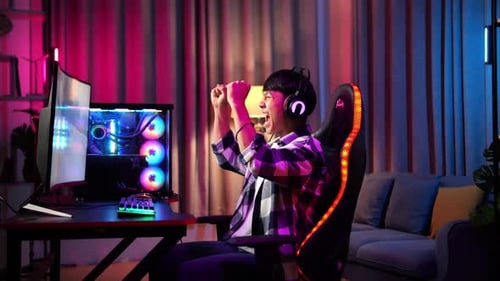 Excited Gamer Playing Racing Game at Night