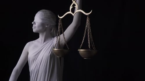 Themis is Lifting the Golden Scales Close Up Footage Blindfold on the Face