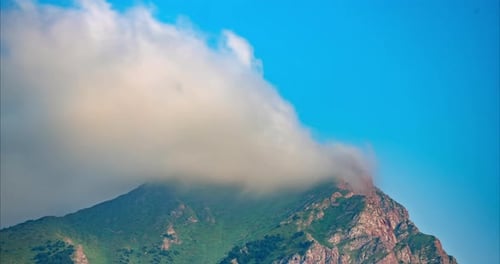 Timelapse of Clouds Over a Mountain Peak