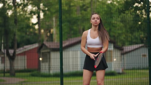 Young Woman Playing Tennis on an Outdoor Court