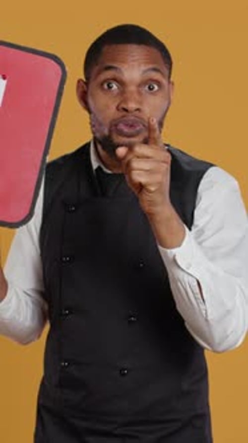 Vertical Video Catering Employee Showing a Message to Vote on Red Speech Bubble