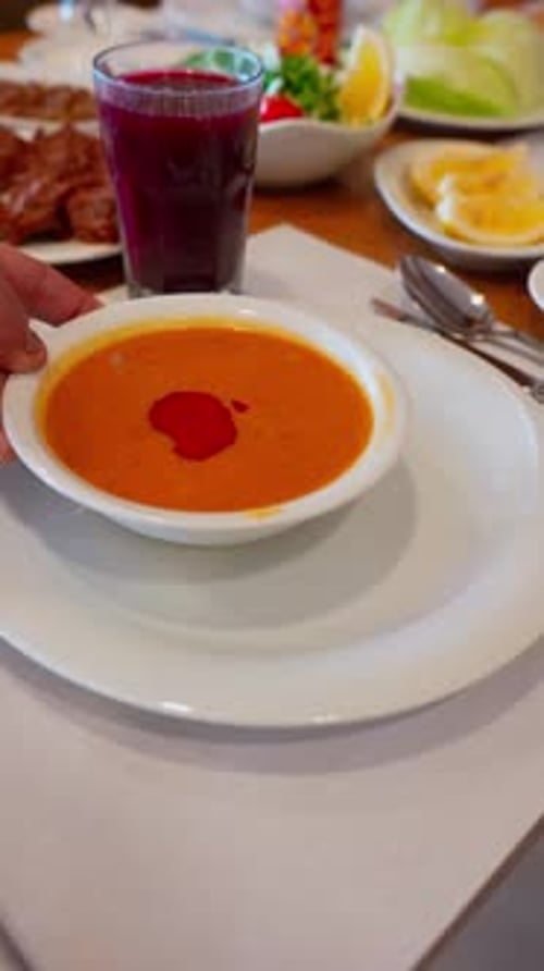 Delicious Soup and Drink on Restaurant Table