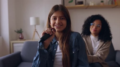 Girl Singing with Microphone at Home