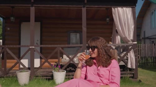 Peaceful Backyard Setting Featuring Woman Enjoying Drink Tranquil Garden Environment Where Woman