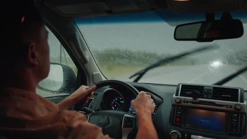 Limited Visibility Driving Man Steers the Car on a Narrow Rural Road During Heavy Rain Shower with