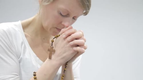 Woman Praying with Rosary Beads