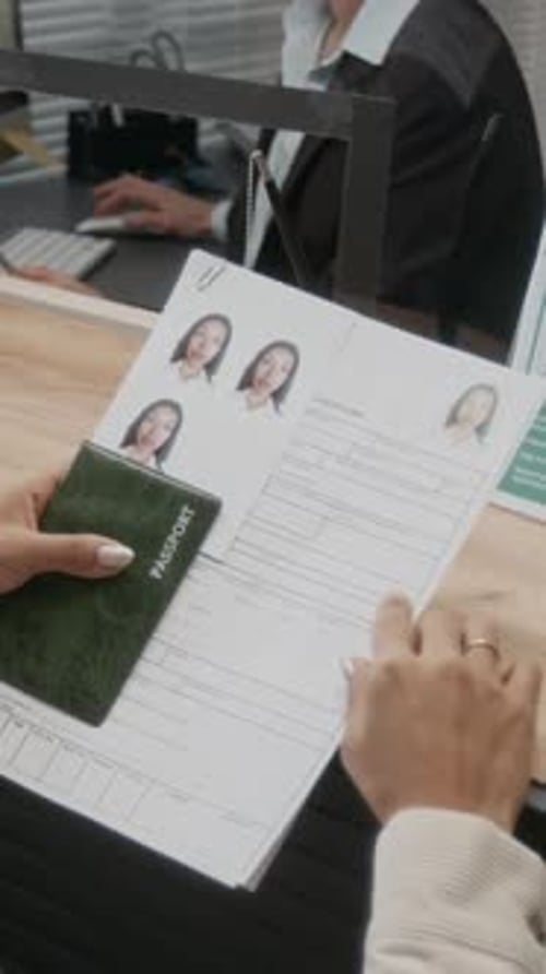 Vertical of Anonymous Woman Checking Application Form at Visa Center