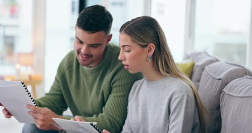 Smiling Couple Plans Together at Home