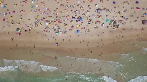 Summertime in a public Beach with colorful umbrellas