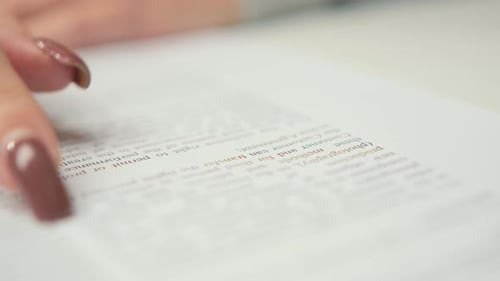 Close-up: woman lawyer office worker proofreading a contract before signing