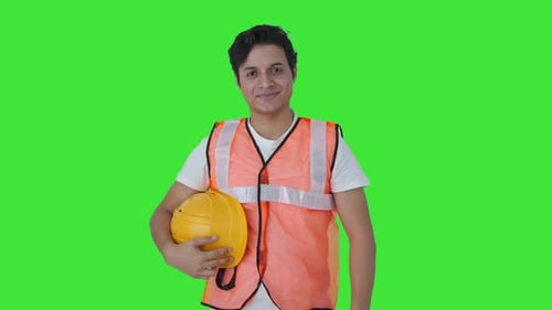 Happy Indian construction labour removing the helmet Green screen