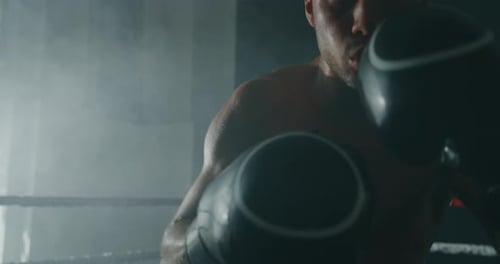 Boxer Training Intense Punching Workout in Ring