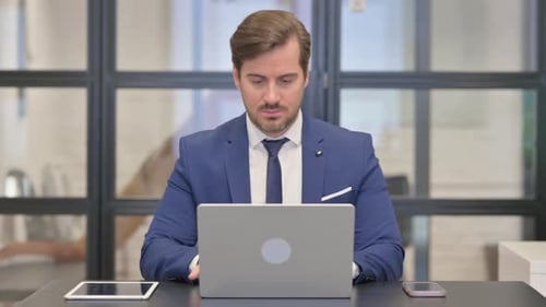 Young Businessman Working on Laptop