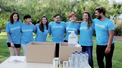 Group of volunteer people work for food donation community service at City Park - Multiracial team