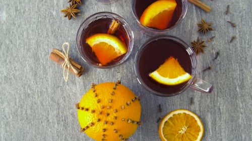 Overhead mulled wine with orange and cinnamon sticks