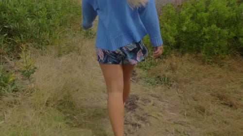 Girl In Blue Sweater Walking With Hair Blowing In The Wind - Track At Crescent Head Lookout And Big
