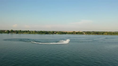 Aerial View on Active Man Riding Jet Ski on Summer Lake