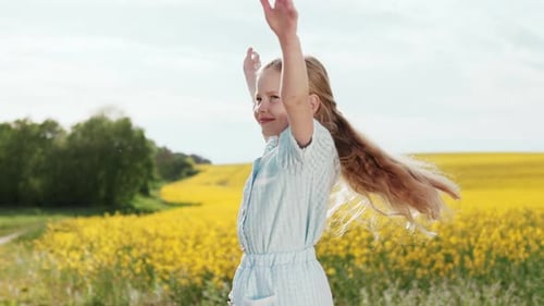 Joyful Girl with Outstretched Arms Turning Around on Field