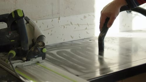 Man Cleaning Surface with Vacuum Cleaner in a Home