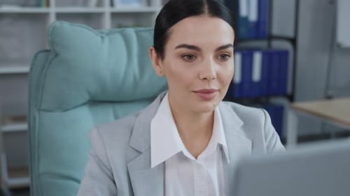 Professional Woman Works on Computer in Bright Office