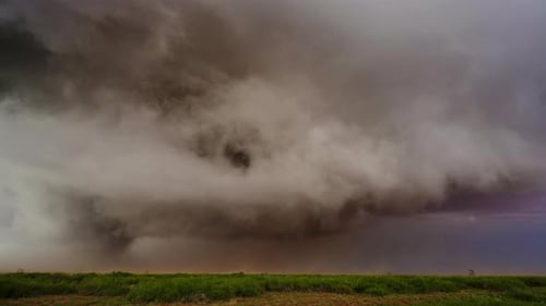 Incoming Storm with Low Clouds Over Open Land