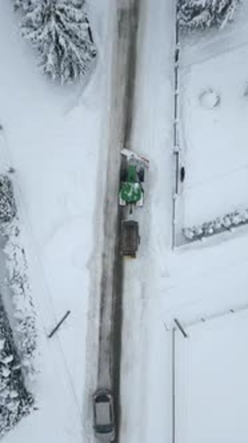 Top View Of Snow Removal Tractor On Road In Winter