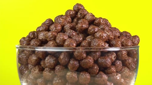 Chocolate Puff Cereal Filling a Clear Bowl