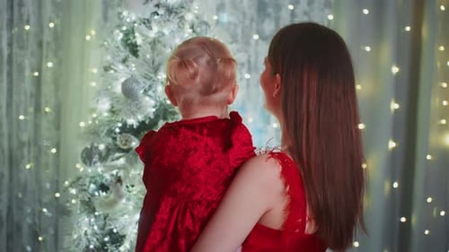 Mother and Daughter Decorating Christmas Tree
