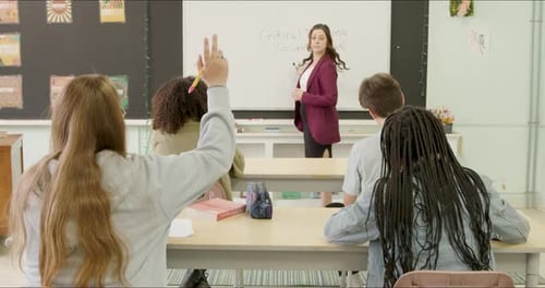 Students Learning in School Class Room. High School or College Class Raising Hand Asking Questions