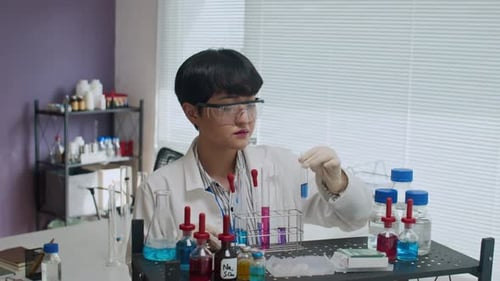 Scientist Examining Test Tubes in Laboratory