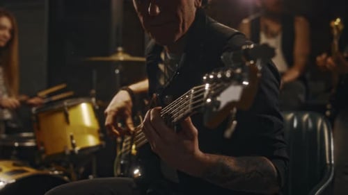 Group of Music Band Members Playing Percussions and Guitars in Studio