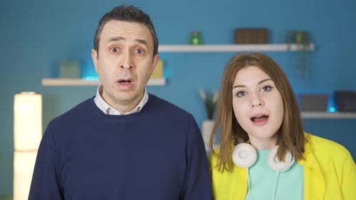 Surprised Man and Woman Looking at Camera Indoors