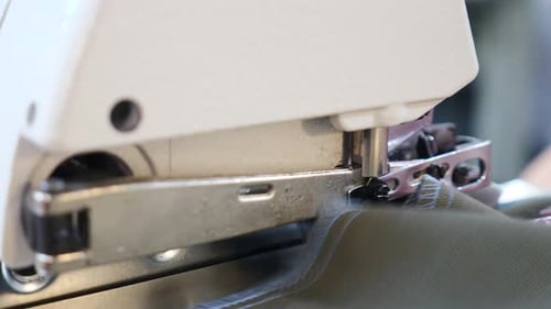 Skilled Female Seamstress Hands Sews Textile Clothes with Electric Sewing Machine at Tailoring