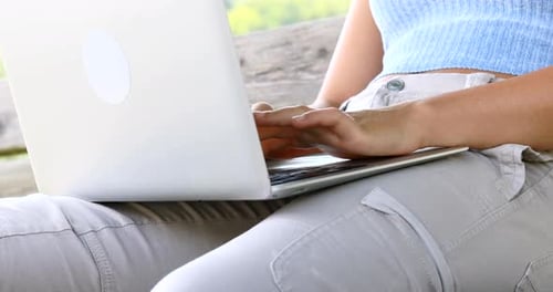 Woman Using Laptop on Bench in Green Park