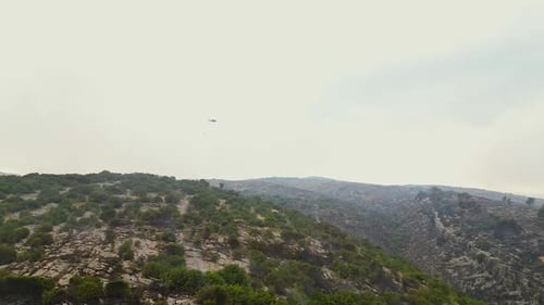 Aerial View of Rolling Hills with Helicopter