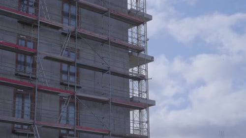 Scaffolding set up next to a building under construction - modern construction - zoom out