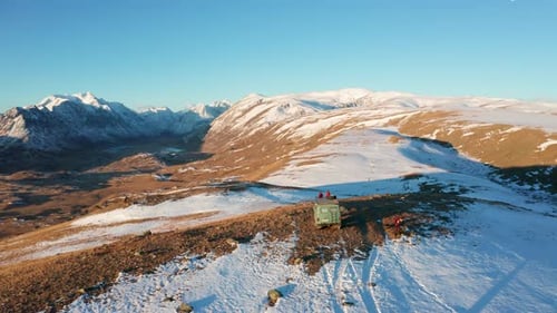 Aerial view of snowy mountains and van, Russia.