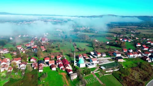 Autumn Charm: Mosque and Village in Morning Mist