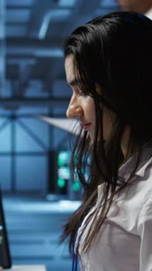 Vertical Video Server Farm Worker Carrying Out Operational Technical Interventions