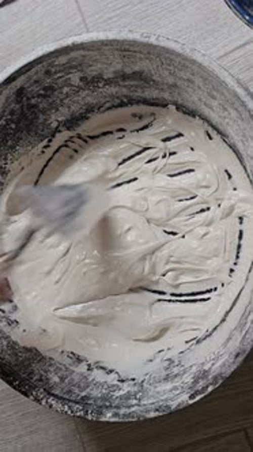 Mixing Compound with Tool in a Round Bucket