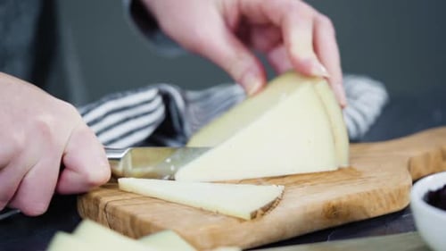 Slicing Cheese on a Wooden Cutting Board