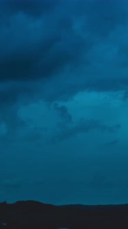 Cloudiness over the night landscape of a rural valley 4k timelapse Vertical video