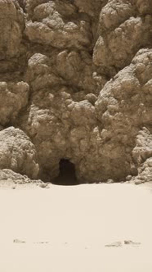A Group of Rocks on a Sandy Beach