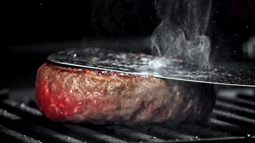 Juicy Burger Patty Sizzling on Grill with Steam