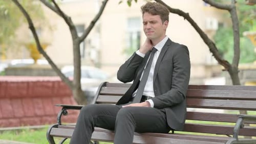 Man in Business Suit with Stiff Neck