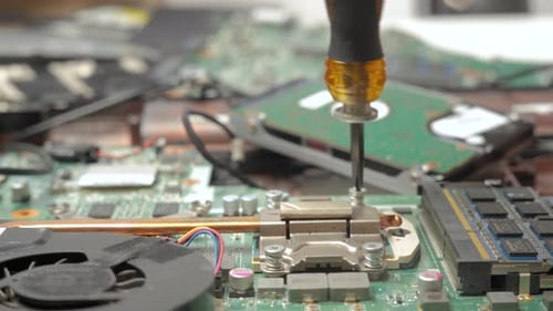 Laptop Motherboard Repair with Screwdriver Close Up