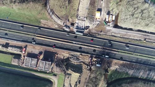 Bird's eye drone shot of a highway and construction site.