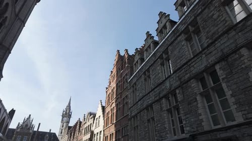 Charming historical alleyway view of Saint Nicholas' Church in Ghent, Belgium