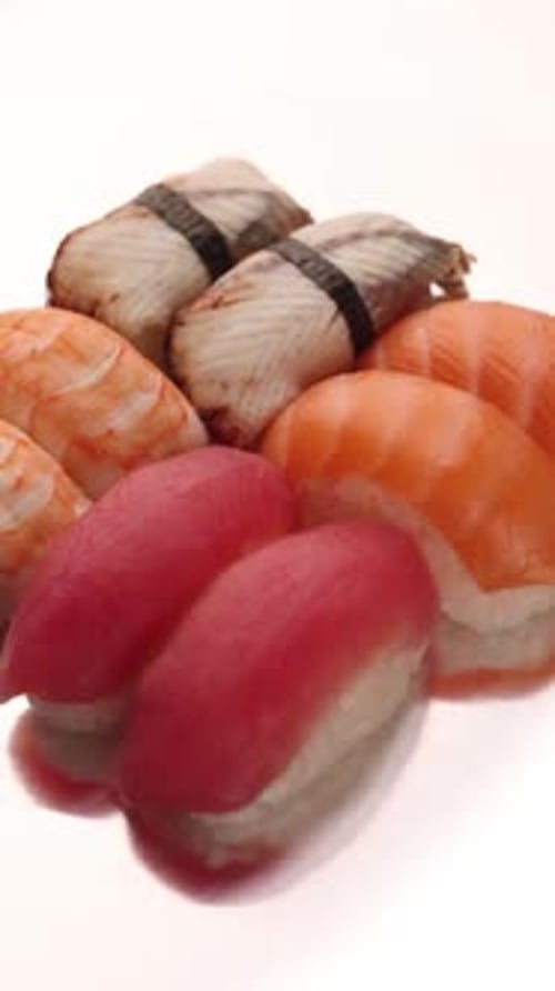 a set of sushi on a silver background, overhead view