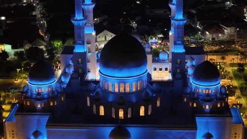 Aerial close up of blue light on Great Mosque in Solo, Indonesia domes. Muslim place of worship.